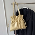 Pale yellow ballet-style drawstring tote bag with decorative bows on a metal hanger - Yellow