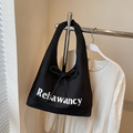 Borsa tote in tela nera con grande scritta Relawancy e dettaglio decorativo con fiocco - Nero