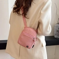 Pink minimalist crossbody bag for women featuring front zipper pocket and round logo - Pink