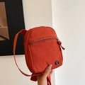 Compact orange-red sporty crossbody phone bag with nylon fabric and circular logo detail - Orange