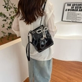 Mini black patent leather backpack with pearl bow and silver chain strap shown on model - With Pendant / Black