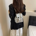 Silver metallic mini backpack with pearl bow charm and chain straps on model - With Pendant / Silver