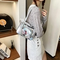 Silver laser ita-bag with heart PVC window and lace bow, styled for shoulder wear - Silver