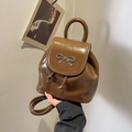 Brown glossy faux leather backpack with silver metal bow and drawstring closure - Coffee