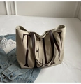 Detail of canvas tote bag with brown leather handles and vintage letter print design - Off White