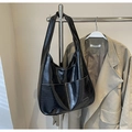 Detail of black oiled wax leather hobo bag with wide strap and front pocket - Black