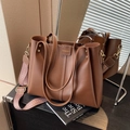 Brown large capacity tote bag with wide geometric patterned shoulder strap and gold accents - Brown
