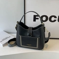 Black bucket bag with white stitching and colorful geometric woven shoulder strap - Black