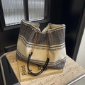 Chic black and white textured tote bag with chain strap on a vintage book - Black