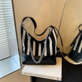 Black and white striped crossbody bag with silver metal chain and leather bottom - Black