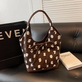 Brown bucket bag with white numeric print and leather trim displayed on a leather sofa - Coffee