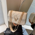 Detail of beige quilted crossbody bag with gold chain strap and circular metal lock clasp - Off White