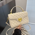 Warm white quilted crossbody bag with gold hardware and elegant top handle strap - Off White
