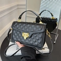 Quilted black leather handbag with gold metal hardware and adjustable crossbody strap - Black