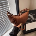 Chic brown leather croissant bag with knotted shoulder strap and textured finish - Brown
