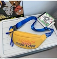 Detail of yellow nylon street bag with bright blue adjustable strap and pixelated text - Yellow