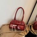Dark red patent leather Boston bag with a pearl bow charm and silver hardware - Red