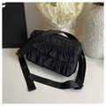 Elegant black pleated crossbody bag with ruffle detail and adjustable wide shoulder strap - Black