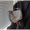 Blue denim handbag with brown leather trim, gold bow detail, and pearl chain strap - Blue