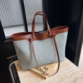 Borsa tote in denim con manici in pelle marrone su superficie di marmo elegante - Marrone