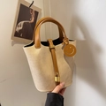 Beige woven bucket bag with brown leather handles and a gold metal padlock detail - Khaki
