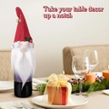 Christmas gnome wine bottle cover with red knit hat and white beard on a festive table - Red