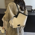 Cream canvas tote bag with black trim and decorative ribbon straps in a stylish daily look - Off White