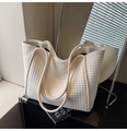 Detail of off-white woven tote bag with minimalist texture and slim straps for commuting - White