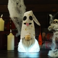 Detail of a glowing Halloween gnome featuring a white ghost hat and a small orange pumpkin - White Light-up Style