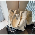 Close-up of canvas tote bag showing side pocket, metal buckle, and thick texture - Beige Grey