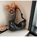 Detail of black pleated faux leather shoulder bag with decorative knotted strap and silver tag - Black