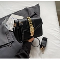Detail of black crossbody bag featuring white stitching and chunky gold chain strap - Black