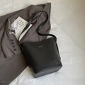 Classic black bucket bag in premium lychee grain leather with elegant gold accents - Black (Without Charm)