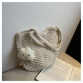 Close-up of cream woven tote bag texture with cute plush cloud pendant detail - Off White