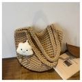 Beige hollow crochet tote bag with cute cloud charm on a rustic wooden table - Khaki