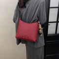 Burgundy litchi grain bucket bag with a cute rabbit plush charm and metal rivets - Ancorra Red
