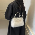 Chic white faux fur handbag with detachable shoulder strap worn by a female model - White