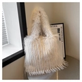 Close-up of white plush faux fur tote bag with long shaggy texture on a metal table - White
