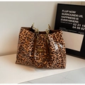 Detail of leopard print tote bag with brown faux leather handles and gold metal chain - Brown