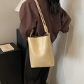 Minimalist cream bucket shoulder bag with quilted stitching and knot strap detail - Apricot