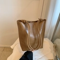 Caramel brown bucket bag with unique patchwork texture and knotted rope handle - Brown