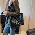 Minimalist black tote bag with glossy wrinkled leather texture and long shoulder straps - Black