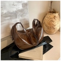 Dark brown shiny faux leather crescent bag with adjustable strap and silver hardware - Brown