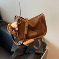 Vintage brown crossbody flap bag with plush monster charm and adjustable strap - Brown
