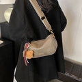 Coffee brown Boston bag with wide canvas strap and plush bear charm shown on model - Mud With Charm