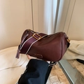 Burgundy Boston pillow bag with wide fabric strap and fringe tassel charm detail - Red Without Charm
