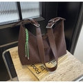 Dark brown suede hobo bucket bag with silver metal buckles and a green rope charm - Brown