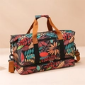Large travel bag featuring colorful maple leaf prints and a separate bottom compartment - Red