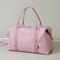 Light pink waterproof travel bag with dual handles and side capacity adjusters - Pink