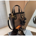 Detail of gray vintage bucket bag with black handles and a cute dog charm accessory - Blackish Green With Pendant